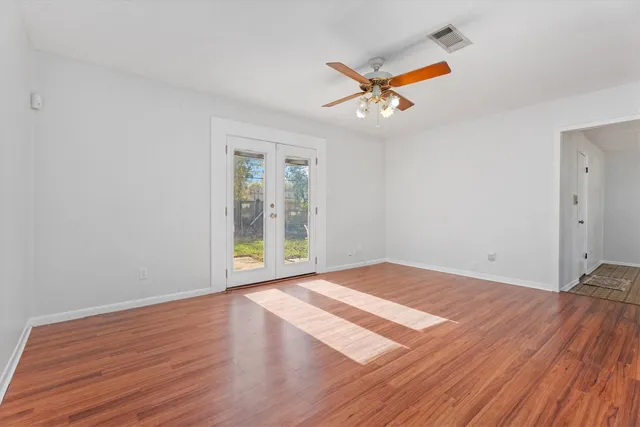 wooden floor in an empty room with a window
