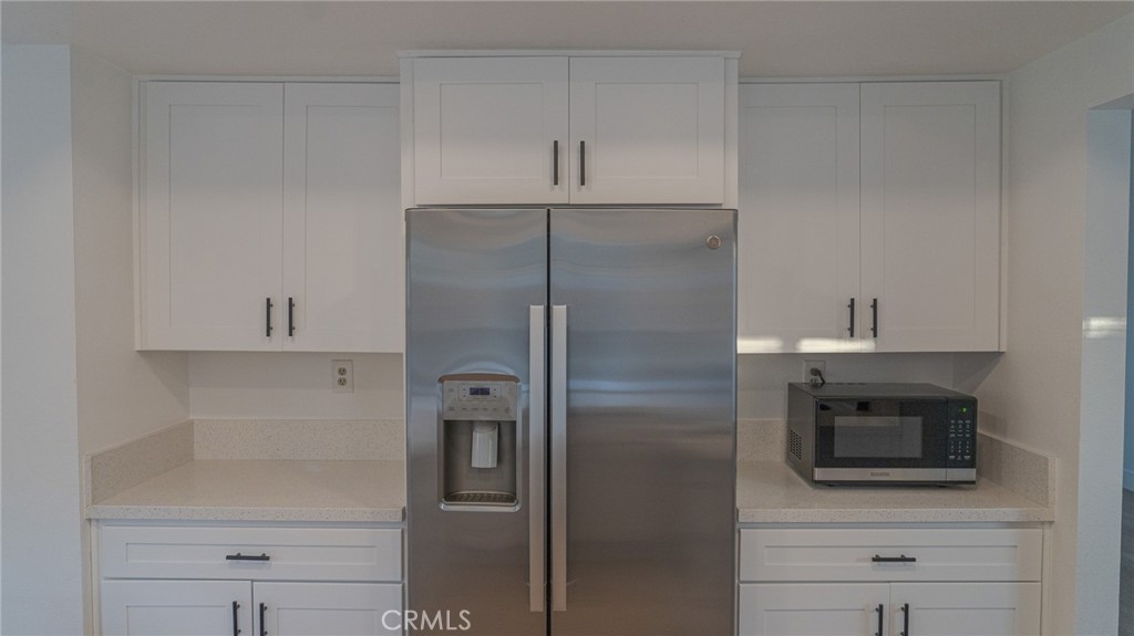 21 Fillmore Irvine, CA 92620 - Photo 13 of 24 a kitchen with a refrigerator and a microwave