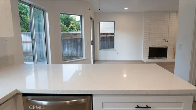 an empty room with wooden floor and a floor to ceiling window