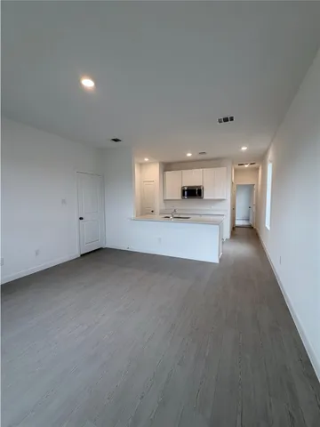 a view of a kitchen with a sink and a stove top oven