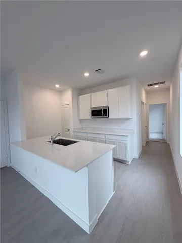a kitchen with stainless steel appliances kitchen island sink stove and cabinets