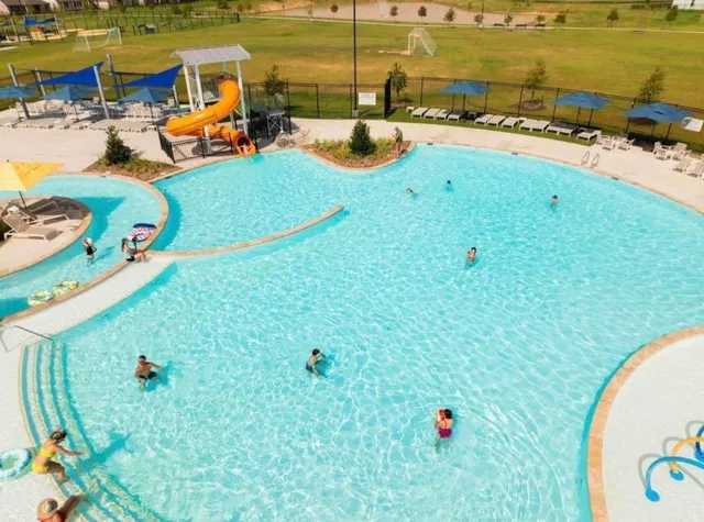 swimming pool with lawn chairs