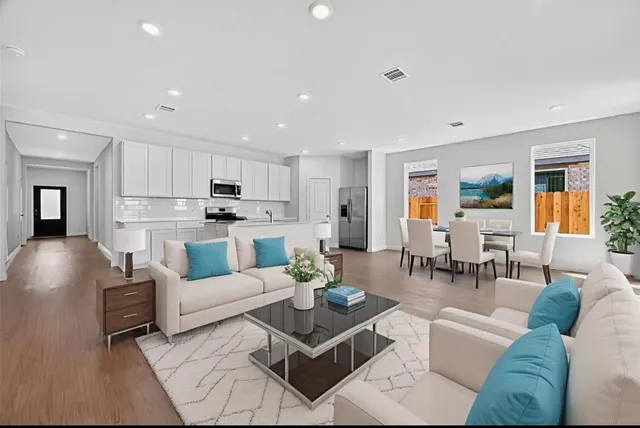 a living room with furniture and a view of kitchen
