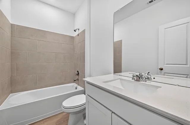 a bathroom with a sink a toilet and a bathtub