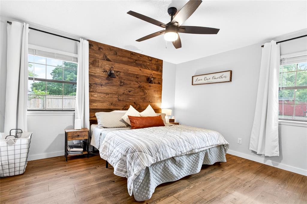 703 College Street Celeste, TX 75423 - Photo 14 of 29 a bedroom with a bed and wooden floor