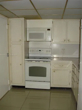 a kitchen with cabinets and steel stainless steel appliances