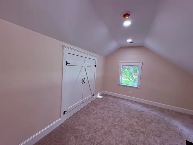 an empty room with windows and closet