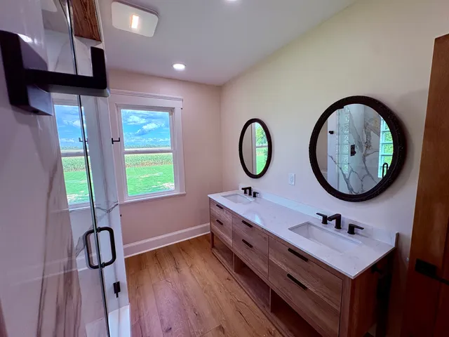 a bathroom with a sink mirror and tub