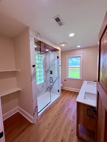 a view of a room with window and wooden floor