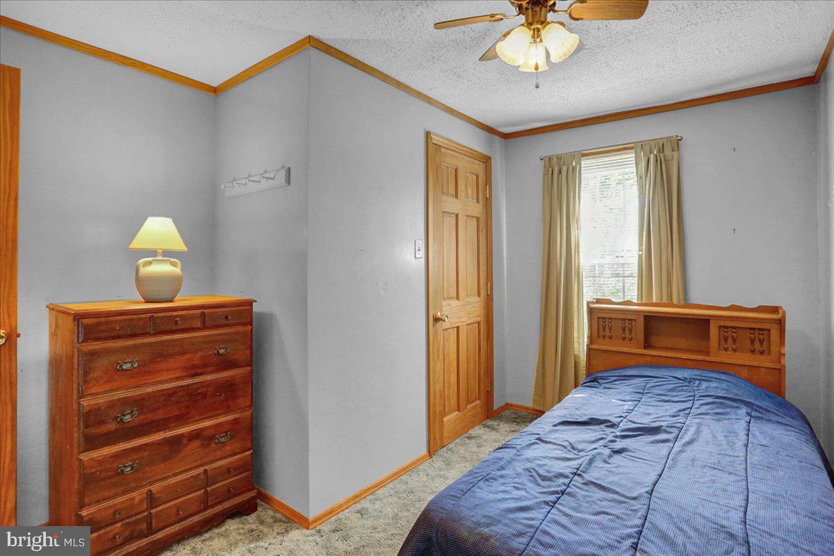 32 2nd Street Shillington, PA 19607 - Photo 12 of 26 a bedroom with a bed and a chandelier
