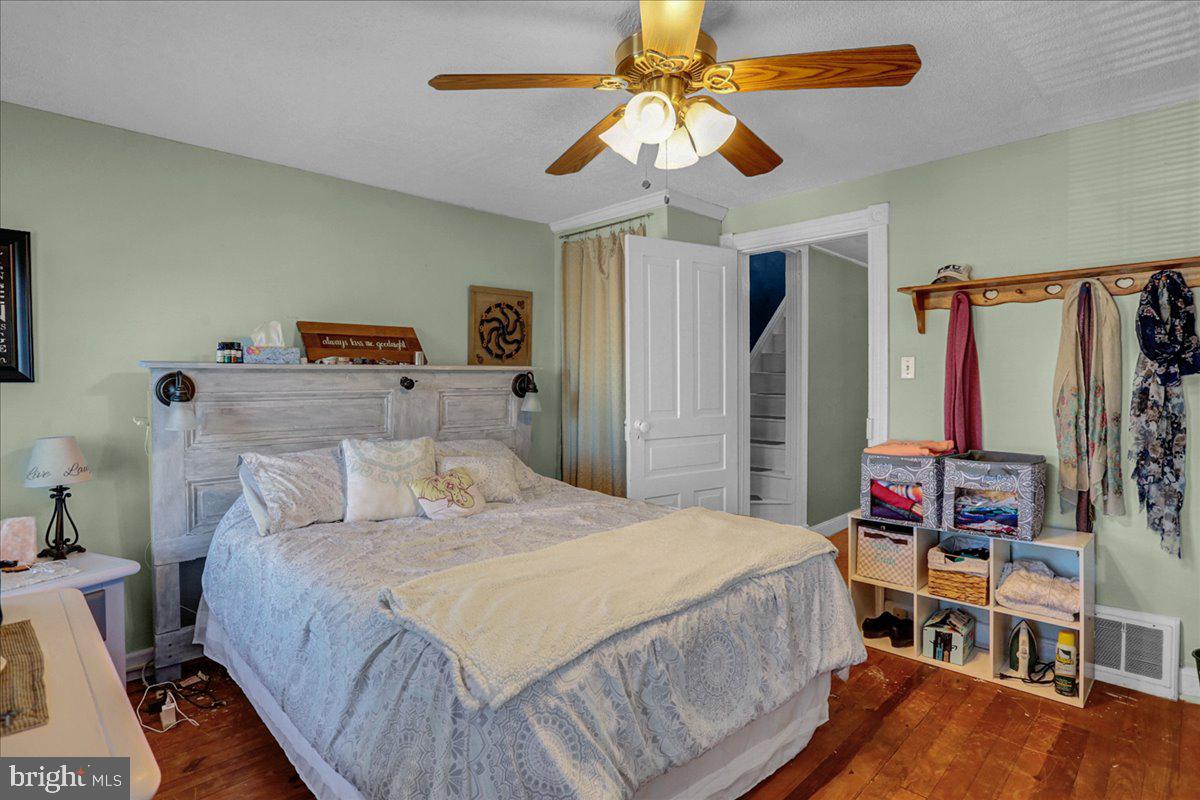 32 2nd Street Shillington, PA 19607 - Photo 14 of 26 a bedroom with a bed and a chandelier