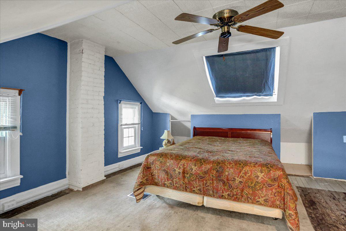 32 2nd Street Shillington, PA 19607 - Photo 16 of 26 a bedroom with a bed and a chandelier