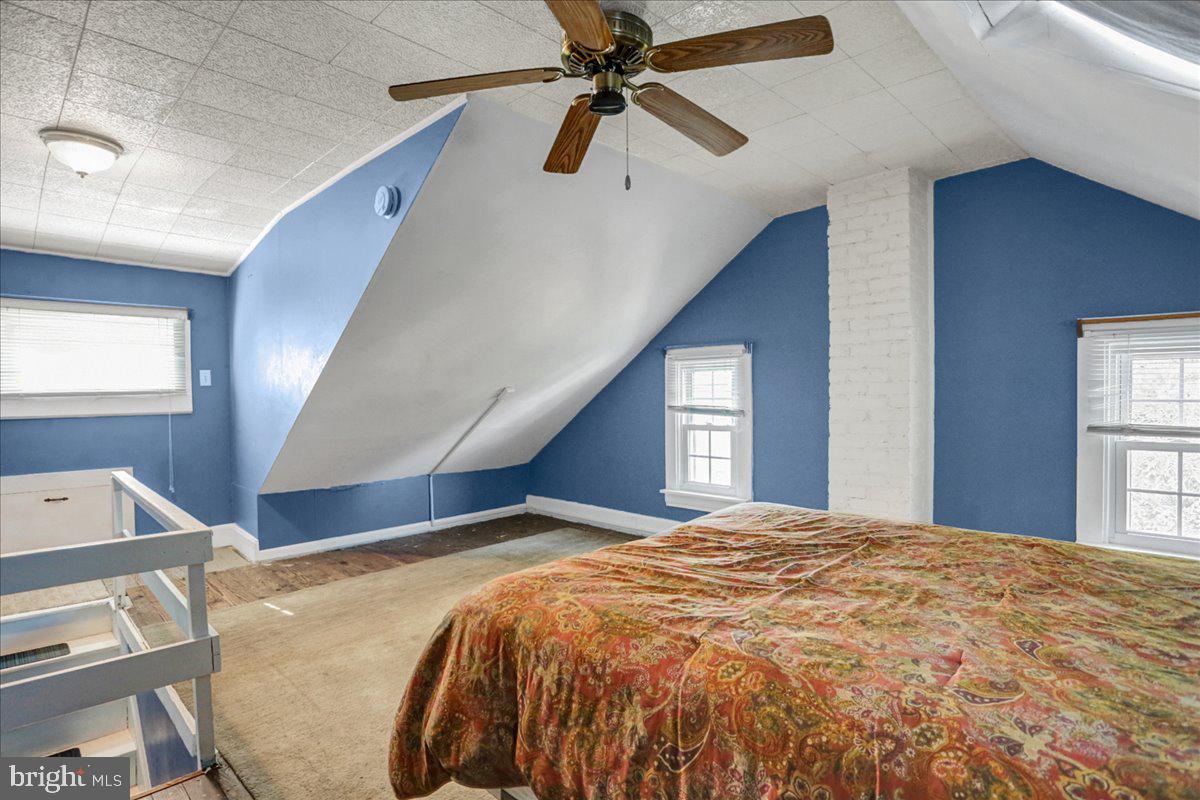 32 2nd Street Shillington, PA 19607 - Photo 17 of 26 a bedroom with a large bed and a chandelier