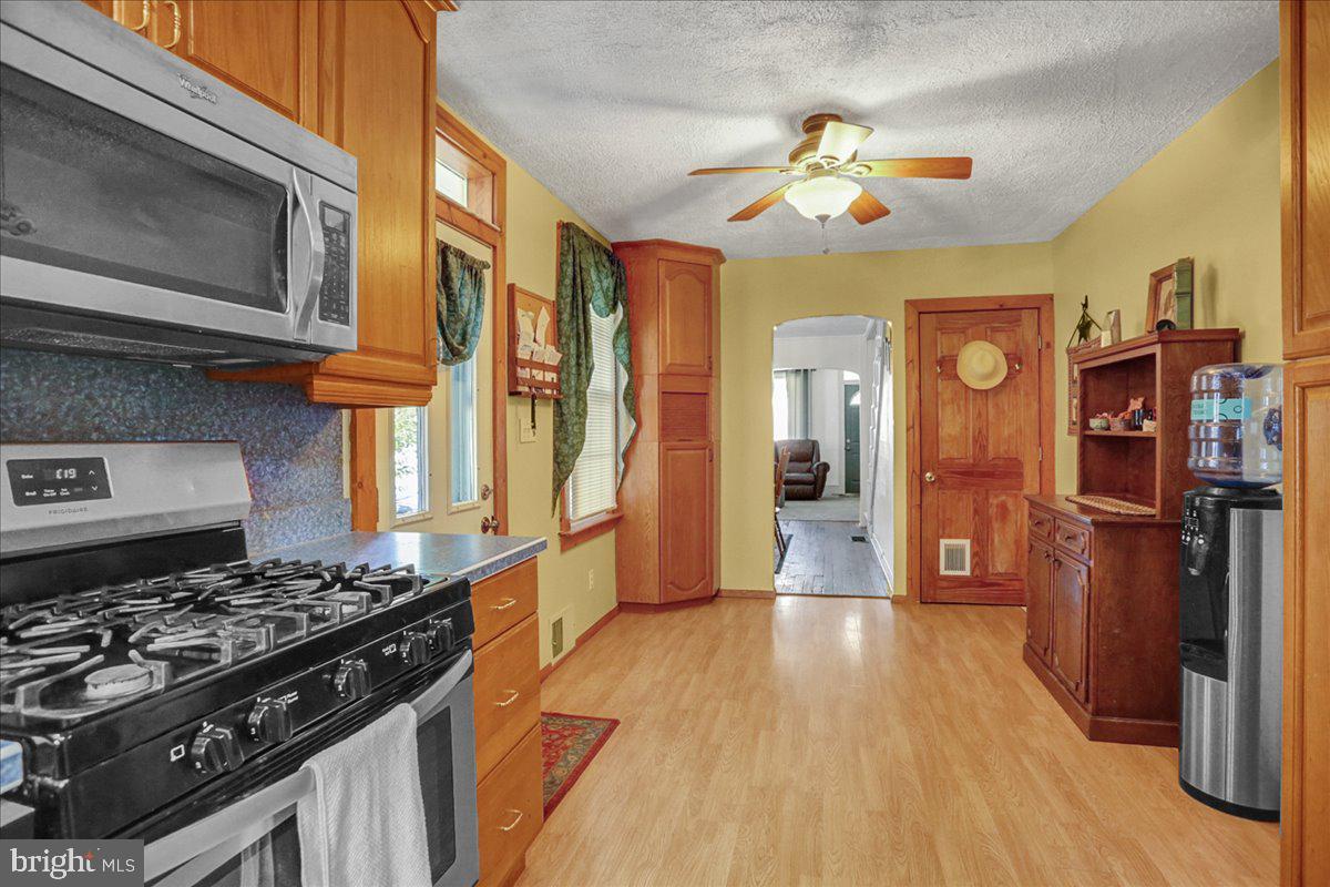 32 2nd Street Shillington, PA 19607 - Photo 9 of 26 a kitchen with stainless steel appliances granite countertop a stove and a wooden floors