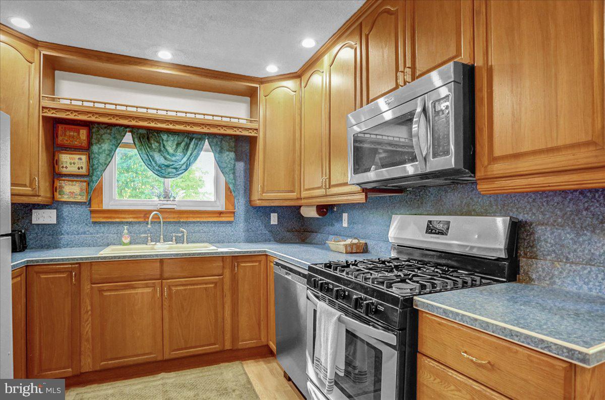 32 2nd Street Shillington, PA 19607 - Photo 10 of 26 a kitchen with stainless steel appliances granite countertop a stove and a microwave