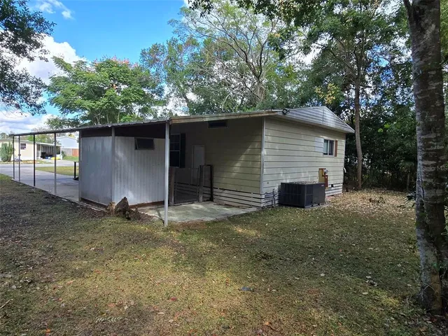 a view of house with backyard and garden