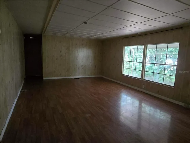 wooden floor in an empty room with a window