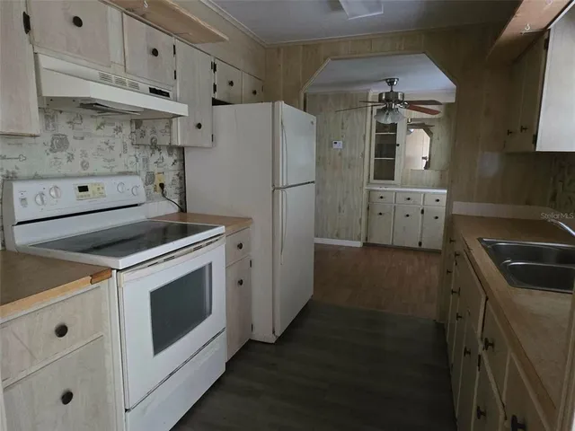 a kitchen with a stove sink and refrigerator