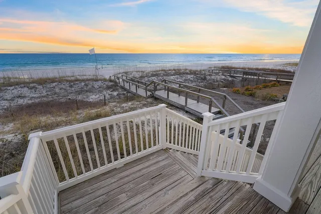 a front view of a house with a yard and balcony