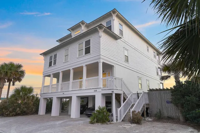 a front view of a house with plants