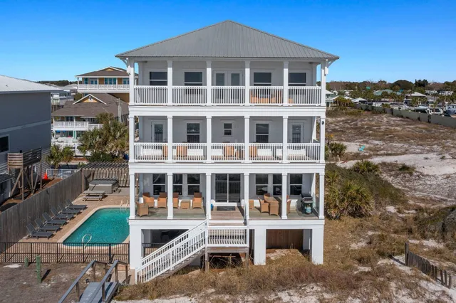 a bathroom with a granite countertop sink toilet mirror and a shower