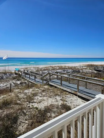 a living room with furniture and a painting on the wall