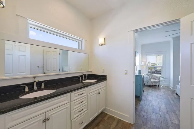a bathroom with a granite countertop sink toilet a mirror and shower