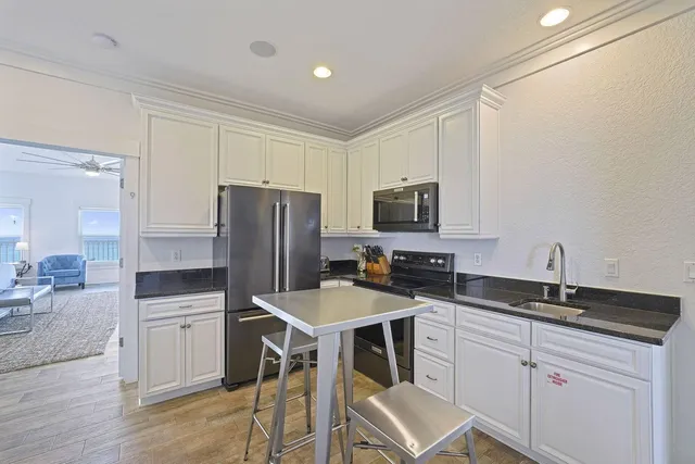 a bathroom with a granite countertop sink toilet a mirror and shower