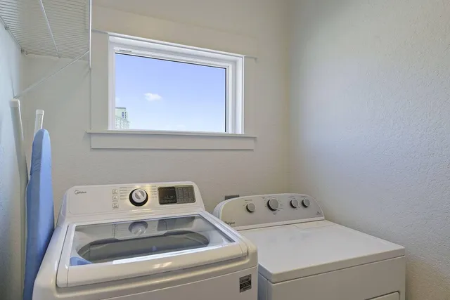 a large bedroom with a bed and wooden floor