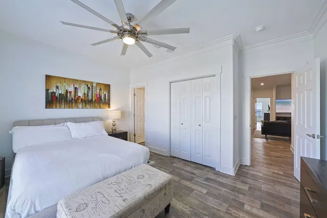 a bedroom with a large bed and a tv on the dresser