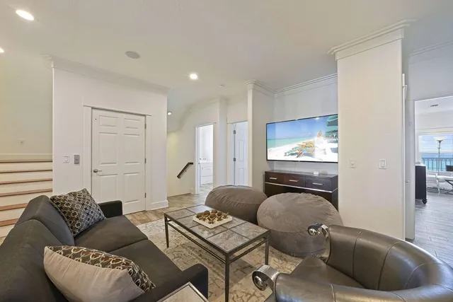 a living room with furniture a fireplace and a chandelier