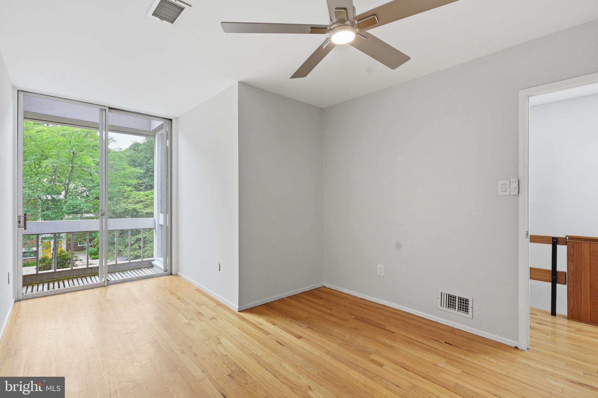 11510 Maple Ridge Road Reston, VA 20190 - Photo 27 of 43 a view of an empty room with wooden floor and a window