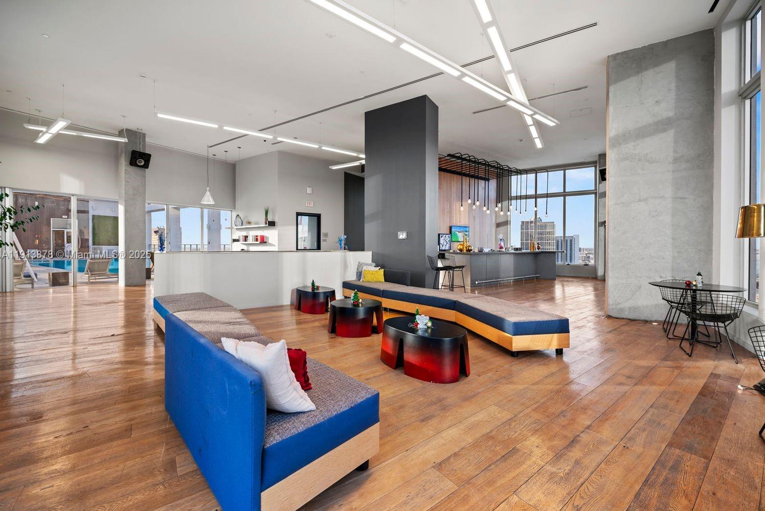 151 Southeast 1st Street, Unit 502 Miami, FL 33131 - Photo 15 of 21 a living room with furniture and a wooden floor