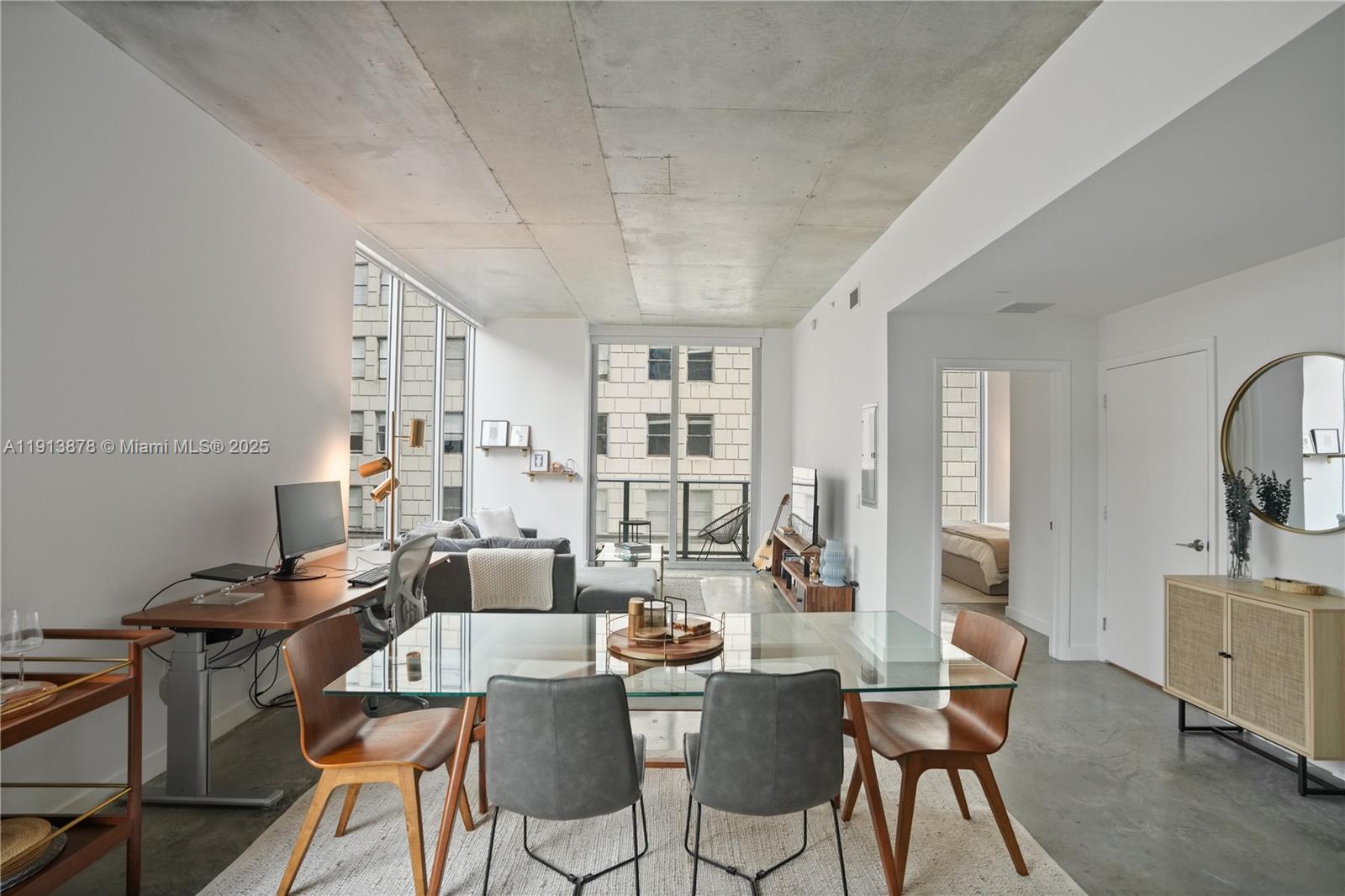 151 Southeast 1st Street, Unit 502 Miami, FL 33131 - Photo 2 of 21 a dining room with furniture and wooden floor