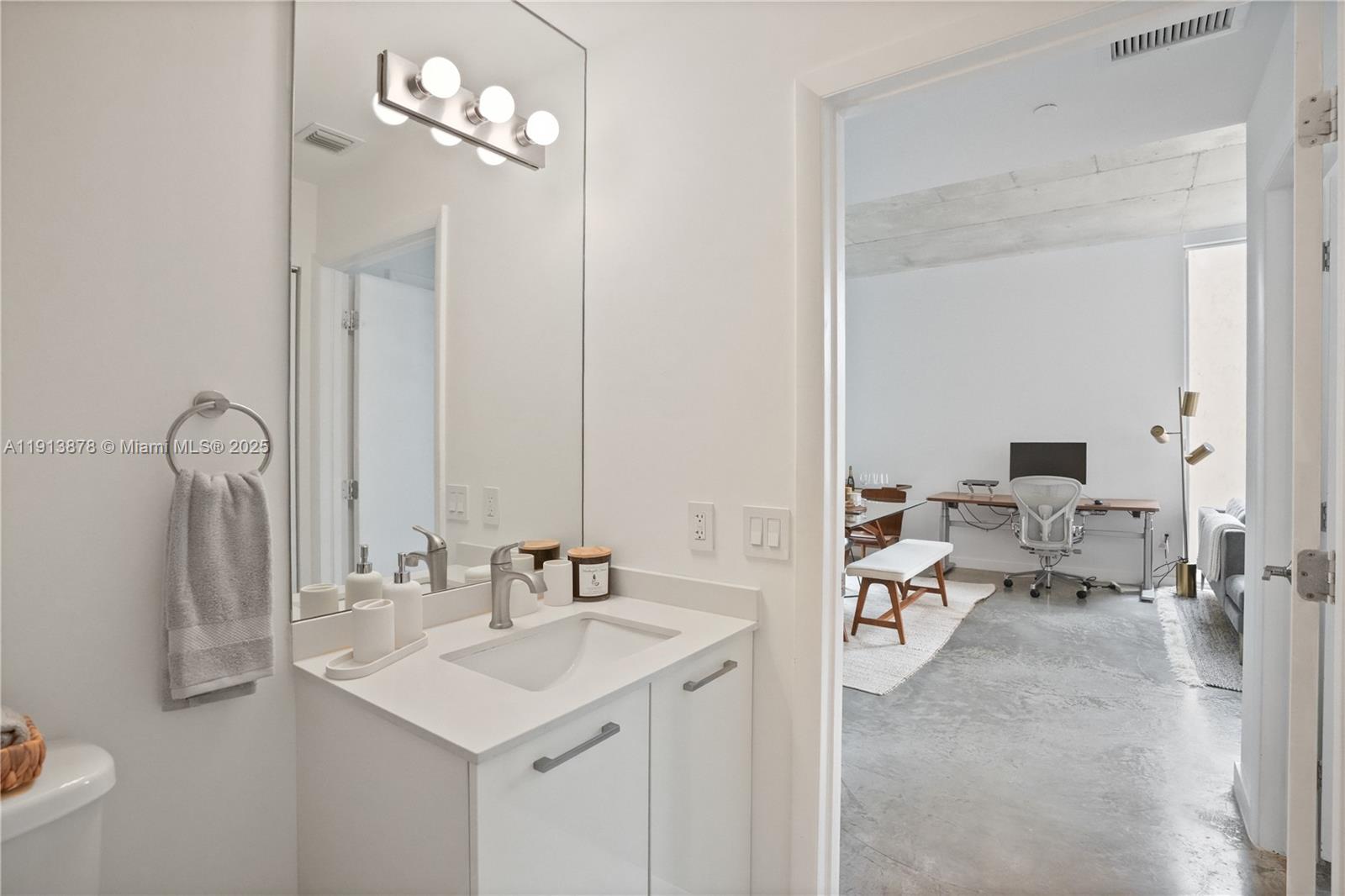 151 Southeast 1st Street, Unit 502 Miami, FL 33131 - Photo 7 of 21 a en suite bathroom with a sink granite and a mirror