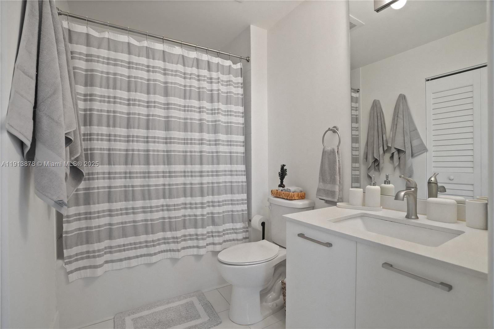151 Southeast 1st Street, Unit 502 Miami, FL 33131 - Photo 8 of 21 a bathroom with a sink a toilet and shower
