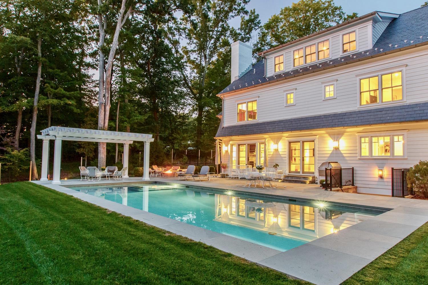 a view of a house with swimming pool and a yard