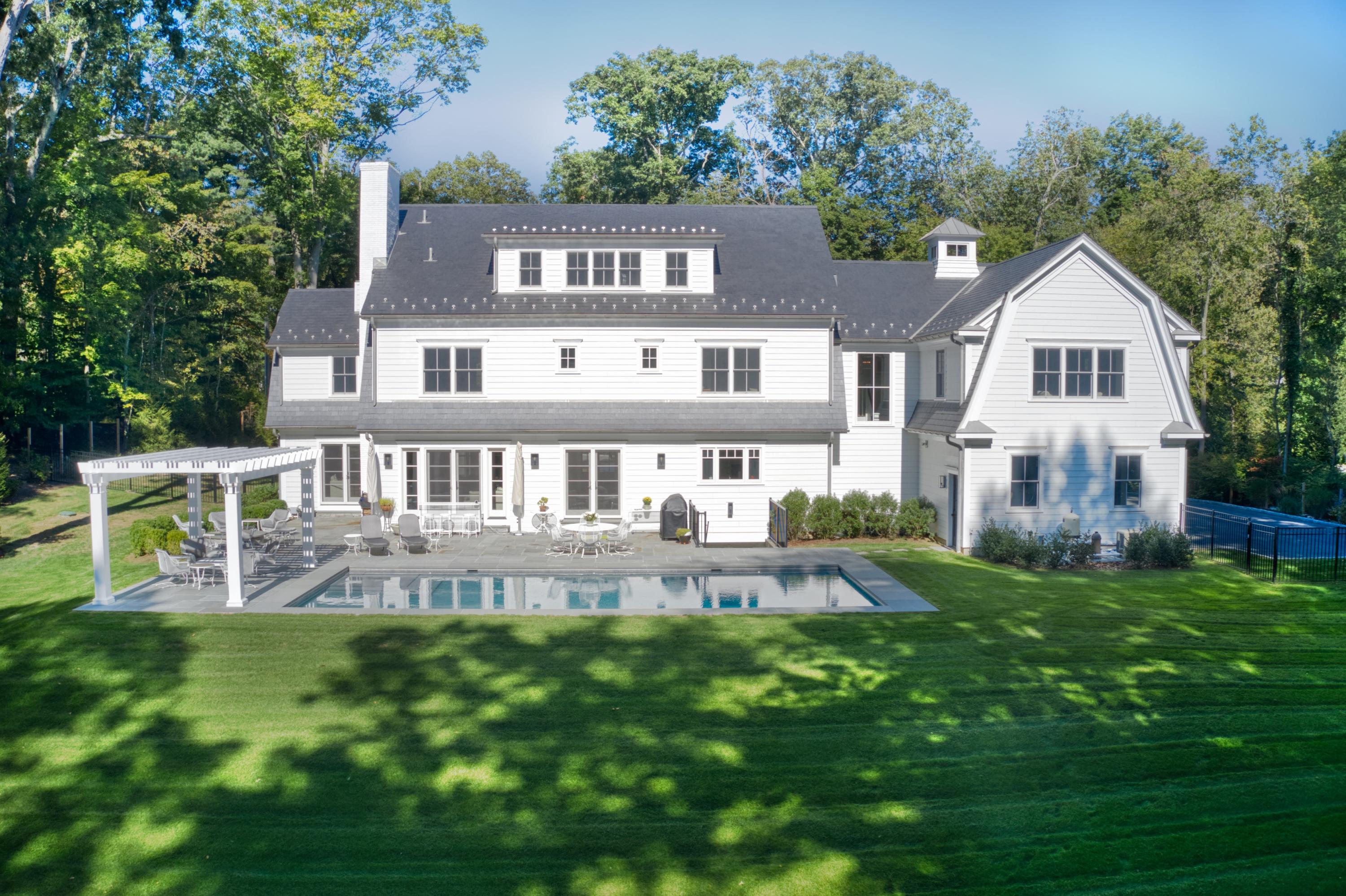 75 Parish Road New Canaan, CT 06840 - Photo 3 of 30 a front view of a house with a yard table and chairs