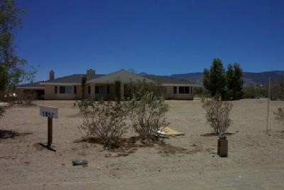2837 Sequoia Road Pinon Hills, CA 92371 - Photo 1 of 1 a view of a house with a yard and sitting area