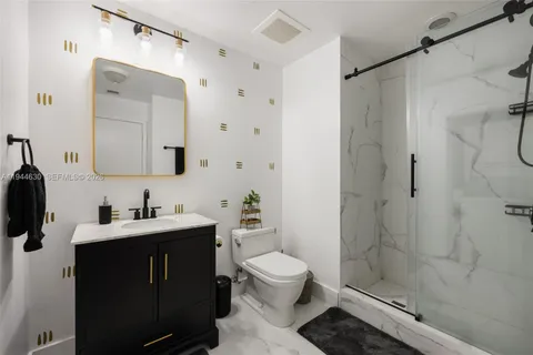 a bathroom with a sink toilet a mirror and shower