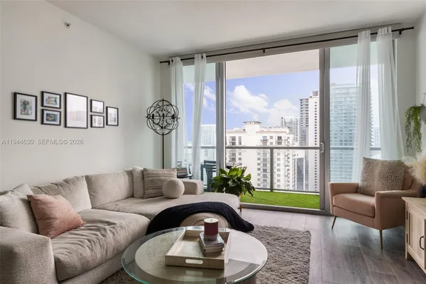 a living room with furniture and a large window