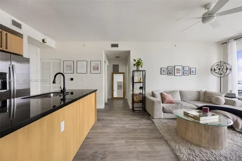a living room with furniture and a sink