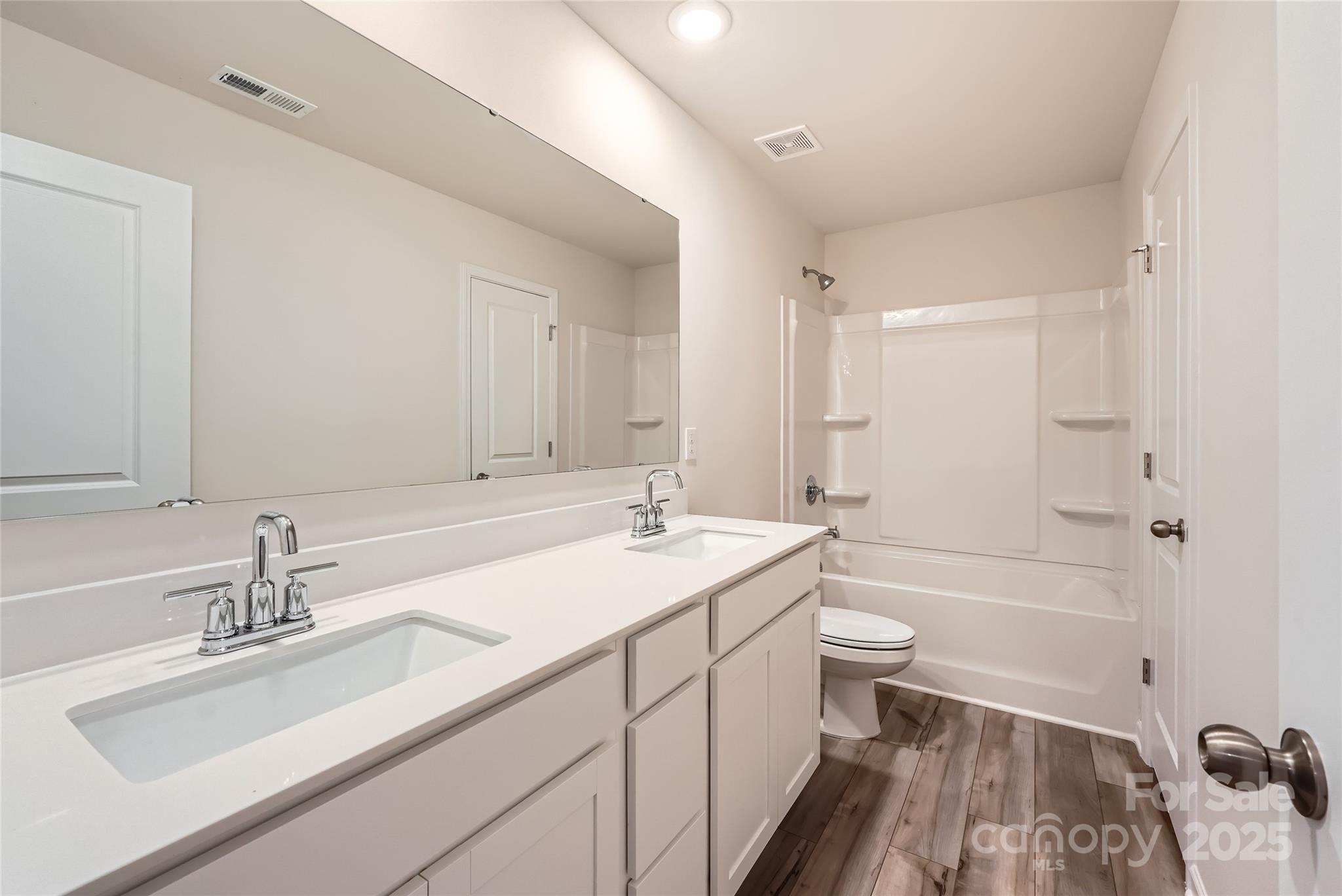 1608 Cannonball Lane Bessemer City, NC 28016 - Photo 11 of 13 a bathroom with a sink double vanity granite toilet tub and shower