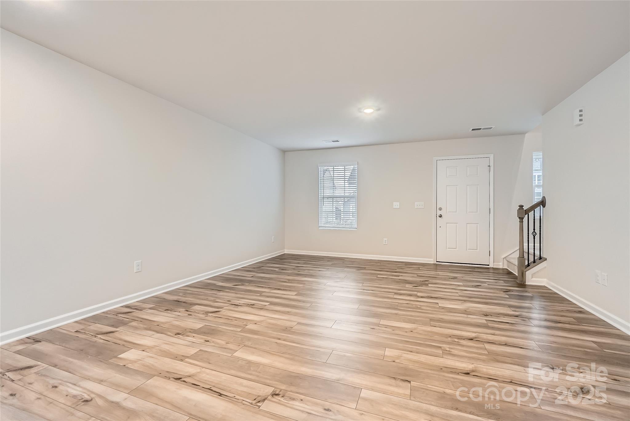 1608 Cannonball Lane Bessemer City, NC 28016 - Photo 4 of 13 a view of an empty room with wooden floor and a window