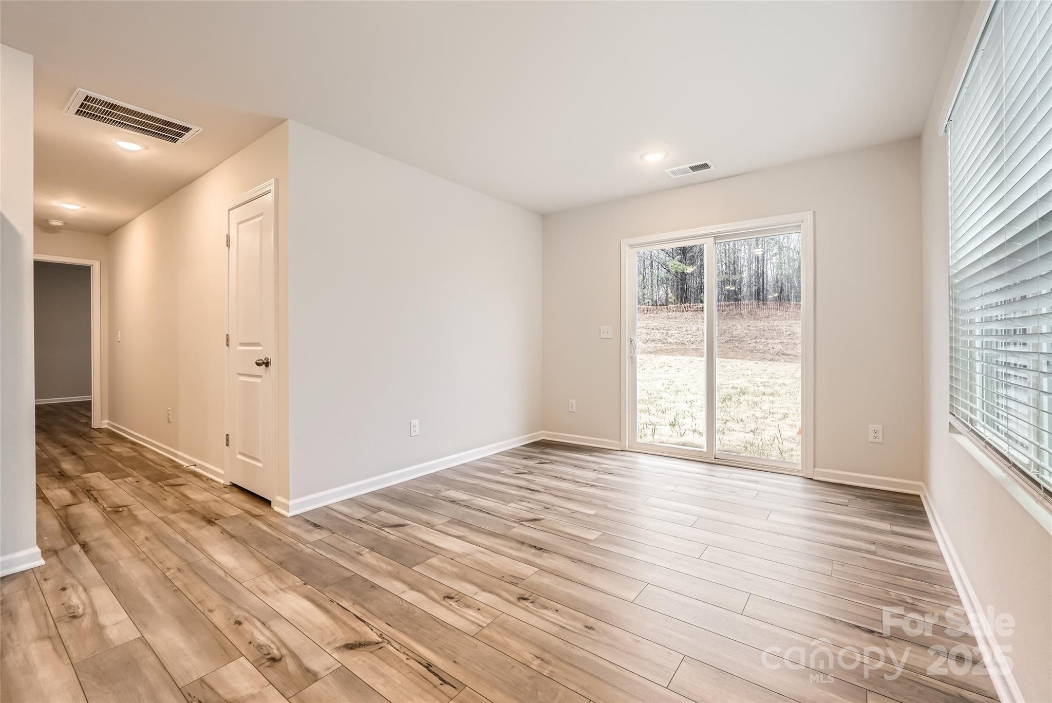 1608 Cannonball Lane Bessemer City, NC 28016 - Photo 6 of 13 a view of an empty room with wooden floor and a window