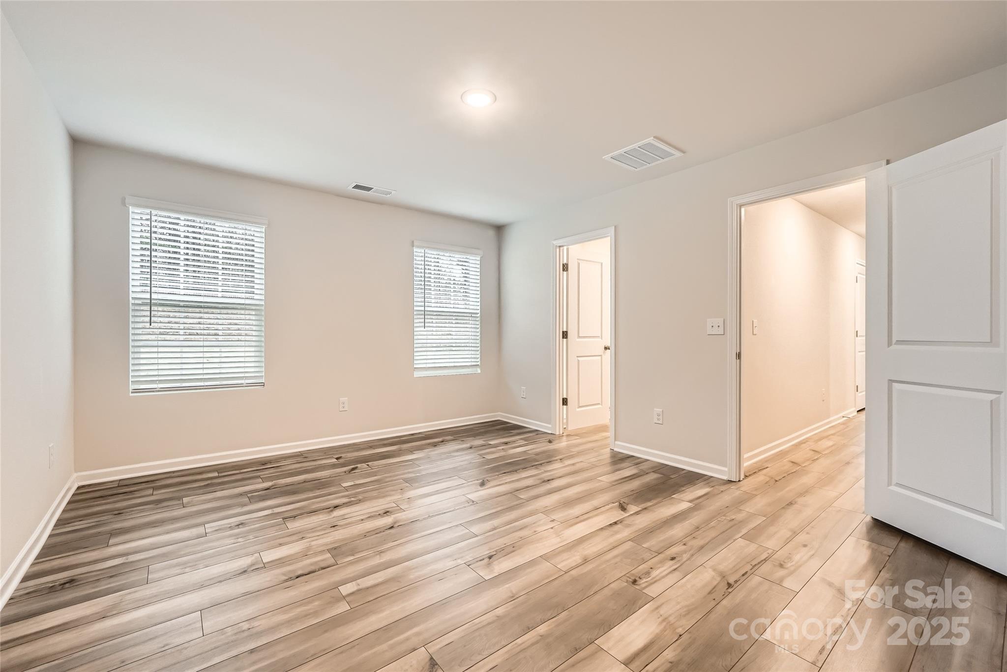1608 Cannonball Lane Bessemer City, NC 28016 - Photo 7 of 13 an empty room with wooden floor and windows