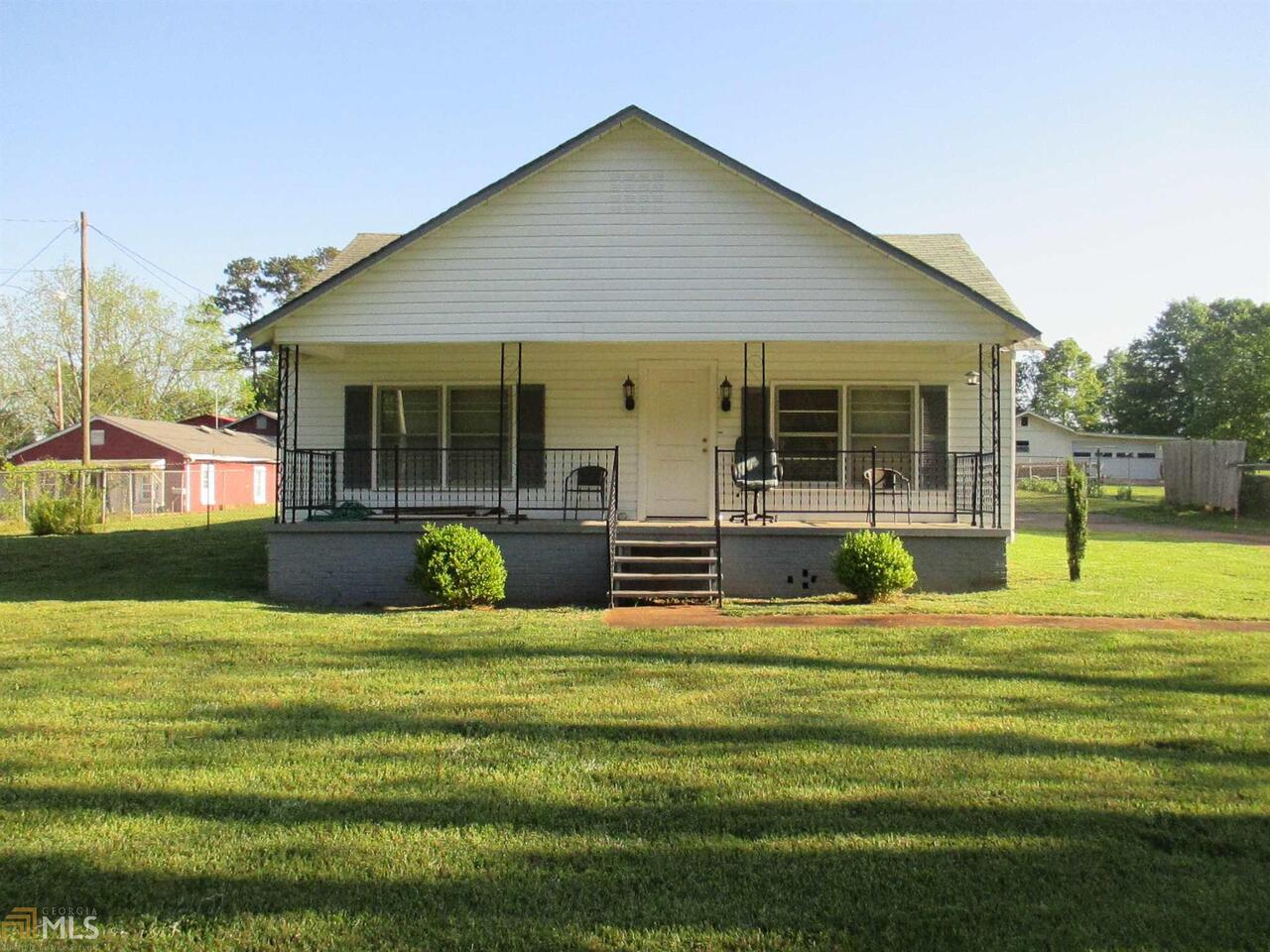 228 Jeff Davis Road Thomaston, GA 30286 - Photo 1 of 1 a view of a house with a big yard potted plants and large tree