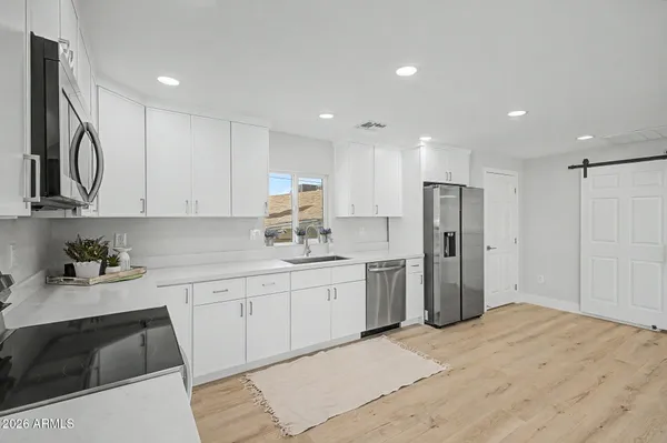 a kitchen with a sink cabinets and window