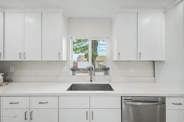 a view of a kitchen with a sink and a stove top oven