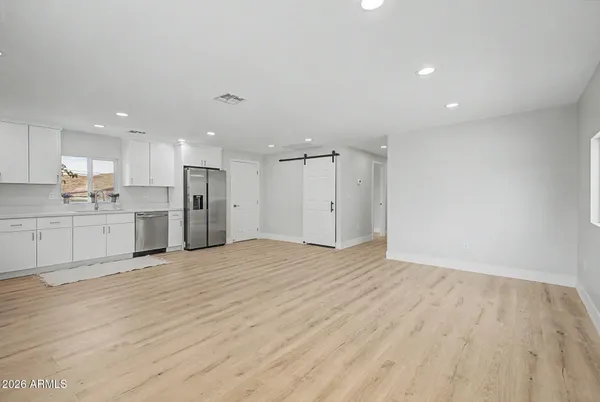 a view of a hallway with wooden floor